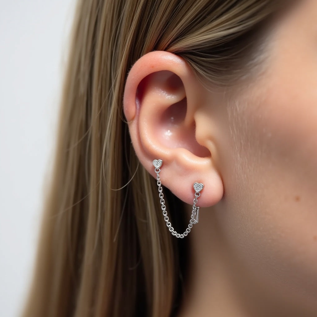 Close-up of an ear wearing a silver double pierce earring with diamond  heart details.