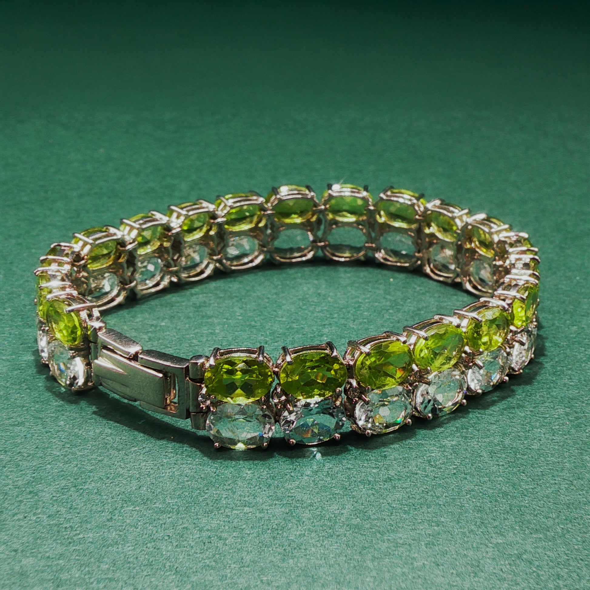 Bracelet with green gemstones on a green background