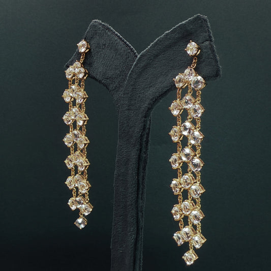silver earrings with dangling beads on a green velvet stand.

