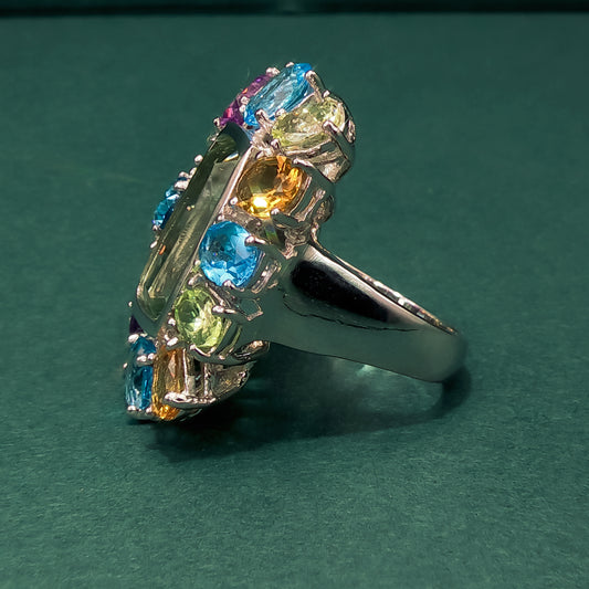 Multicolored gemstone ring on a dark background