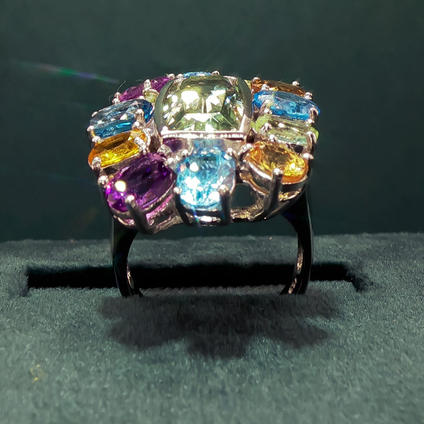 Multicolored gemstone ring on a dark background