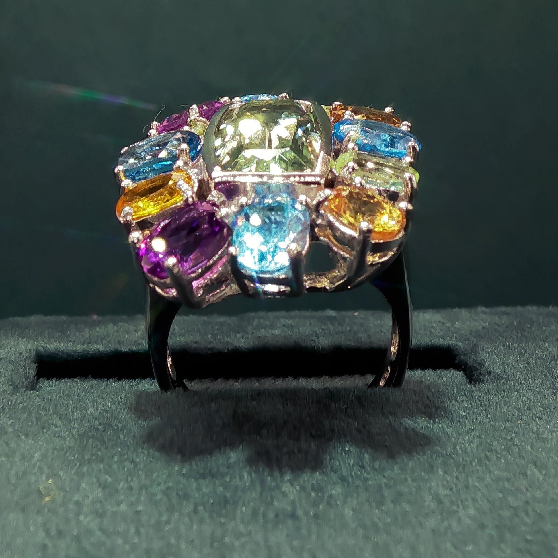 Multicolored gemstone ring on a dark background