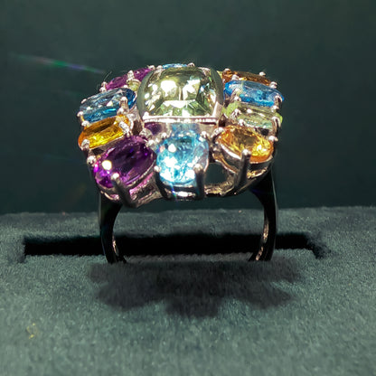 Multicolored gemstone ring on a dark background