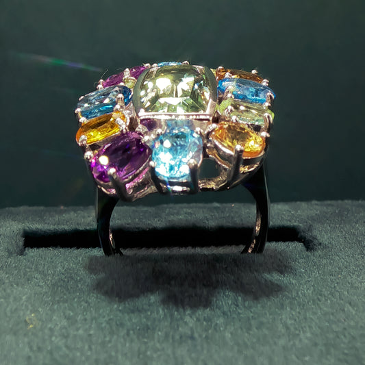 Multicolored gemstone ring on a dark background