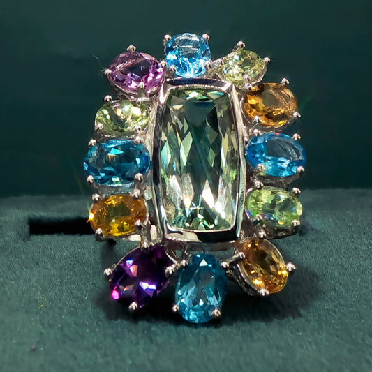 Multicolored gemstone ring on a dark green background