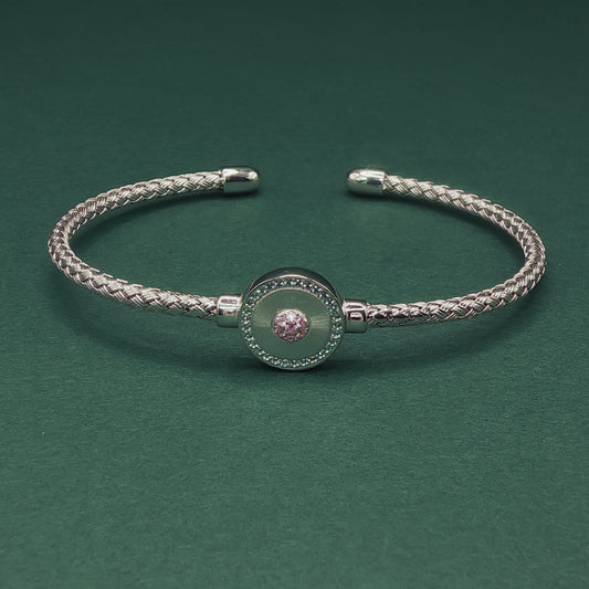 Silver braided bracelet on a dark green background

