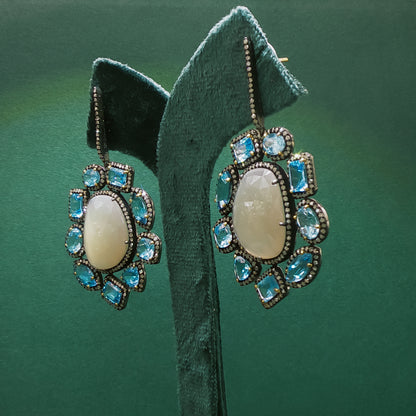 Silver Dangle Earrings with Blue Oval Cabochon Topaz