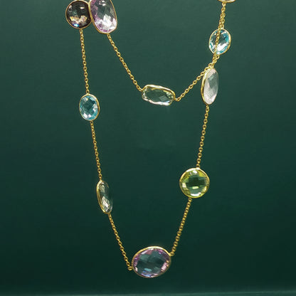 Necklace with multicolored gemstones on a dark green background