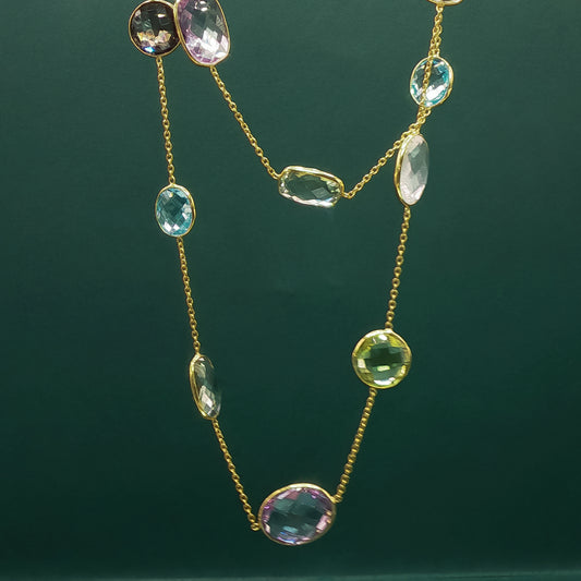 Necklace with multicolored gemstones on a dark green background