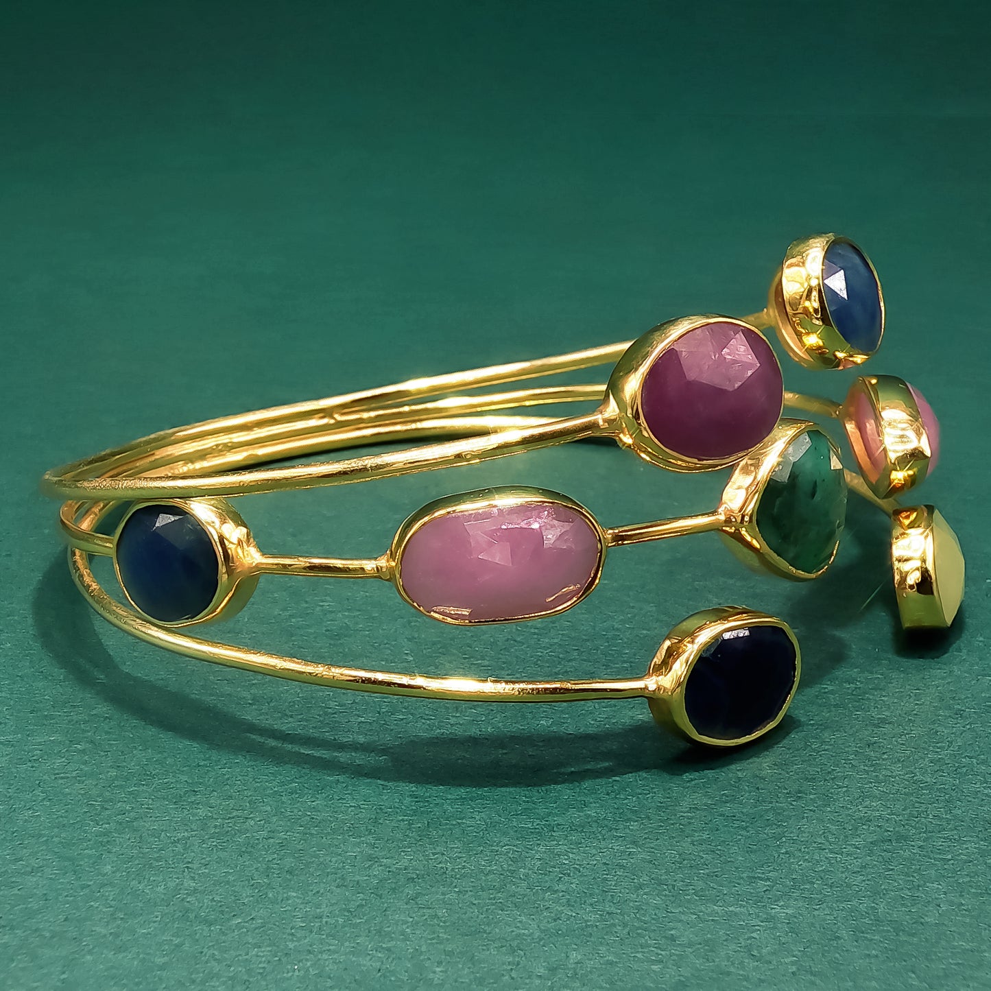 Gold Bangle with Purplish-Red Ruby Cabochons