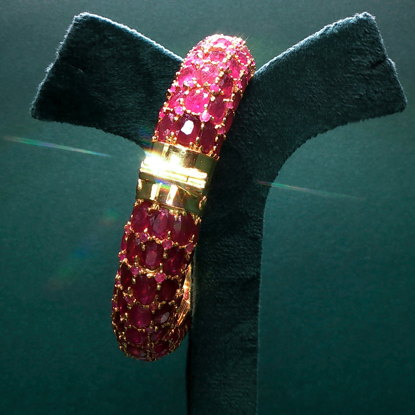 Bracelet with pink gemstones on a green stand