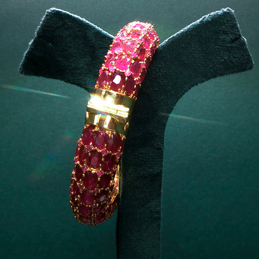 Bracelet with pink gemstones on a green stand