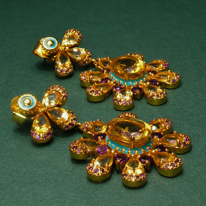 Gold jewelry set with gemstones on a green background