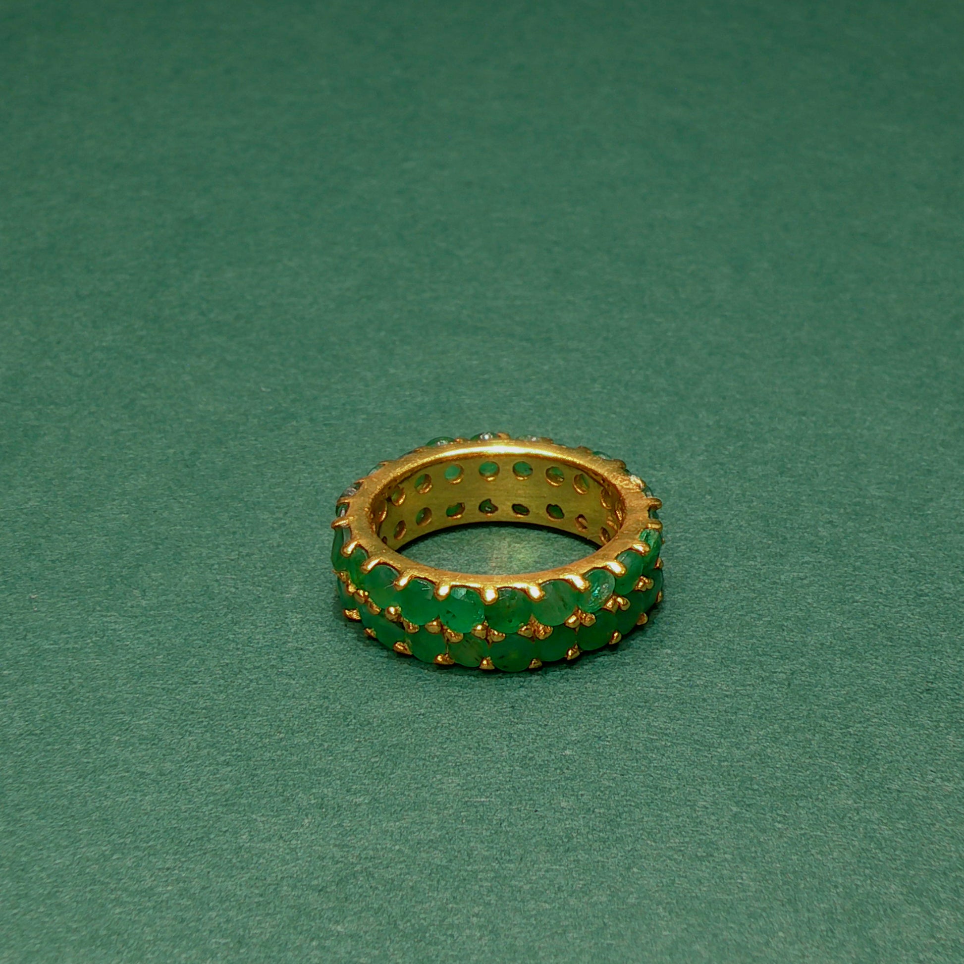 Gold and green ring on a green background
