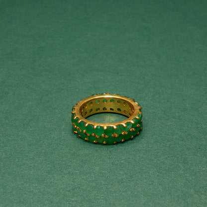 Gold and green ring on a green background