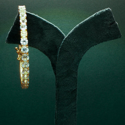 Silver bracelet with diamonds on a green stand

